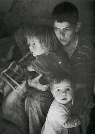 A family in a shipyard, taken by a Rolleiflex. Year?